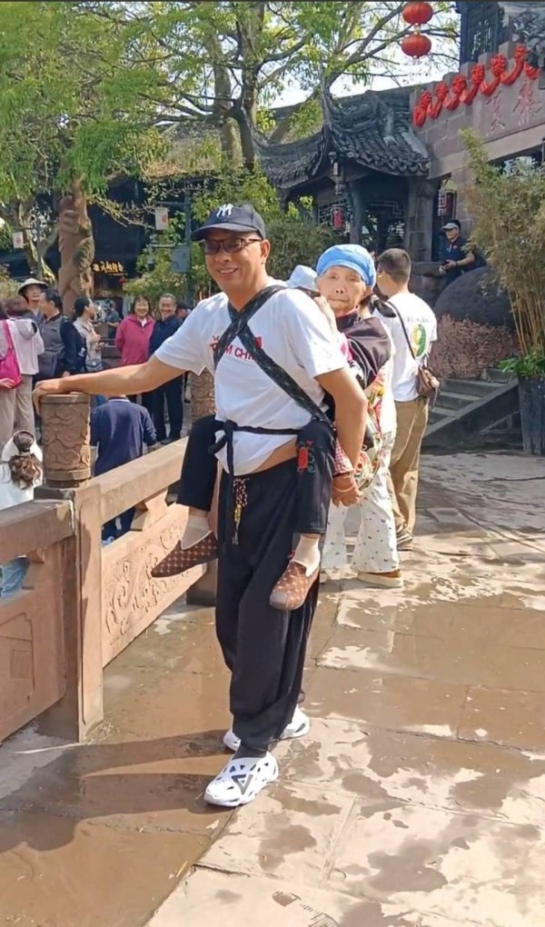 万宝配资 51岁男子背88岁母亲旅游走红：您背我长大，我背您到老